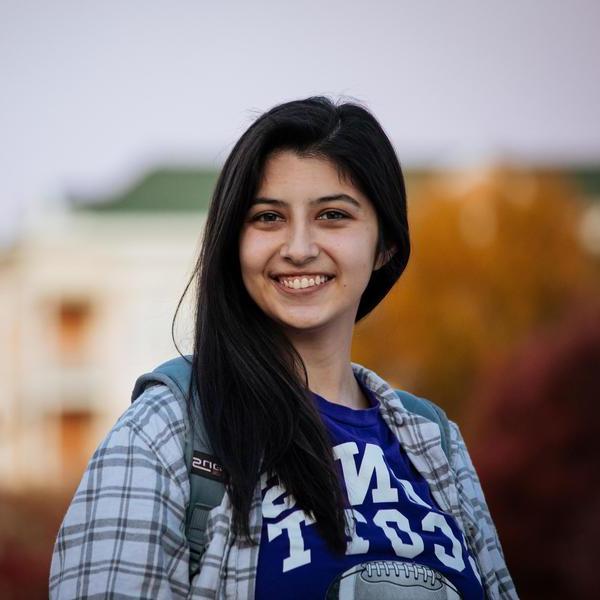 Smiling student with dark hair looks directly at camera.